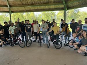 Viking team standing proudly with the five bikes they built for local families.