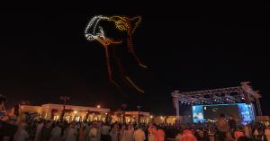 The camel light figure in the sky above the Camel Avenue Festival attendees