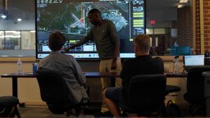 ESTA Team Training at USI's Training Center of Excellence in Panama City, FL - Instructor shown pointing to aviation maps with two students facing the maps.