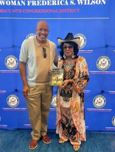 Congresswoman Frederica Wilson receives her copy of Ethan's Good Dad Act