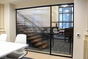 CosciaMoos conference room featuring ZONA 1’s sleek glass partitions.