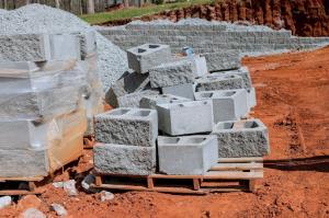 Various concrete materials neatly arranged on a bare construction site, awaiting the start of the project.