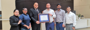 Ibis Styles Dragon Mart team with their CAC certificate.
