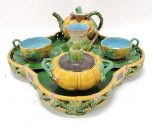 Complete circa 1875 Minton tete-a-tete, shape no. 1349, consisting of a teapot, a sugar, a thistle formed creamer, a pair of yellow cups and green saucers, and a tray (est. $12,000-$15,000).