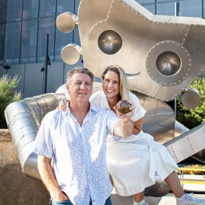 Brad Oldham and Christy Coltrin with Baseball Forever in front of Traveling Man