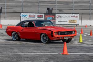 a bright orange '69 camaro racing the autocross
