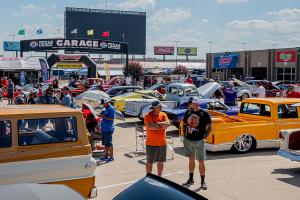 the track infield packed with cool cars and hot rods
