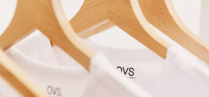 White shirts hanging on wooden hangers