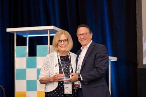 Donna Stidham, RN, accepts the Joy Wheeler Leadership Award from MHPA24 Conference Chair David Jacobson.