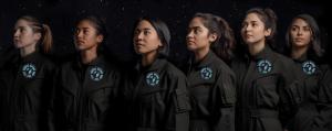 6 diverse looking teenage girls lined up in Cosmic Girls astronaut suits