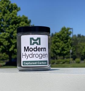 Modern Hydrogen logo on jar of black Modern Solid Carbon sitting outside on sunny day