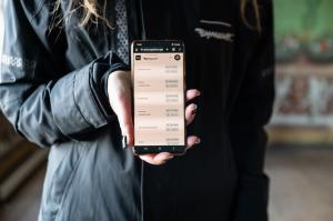 A conservator holds a phone with Bev/Art's mobile-friendly software.