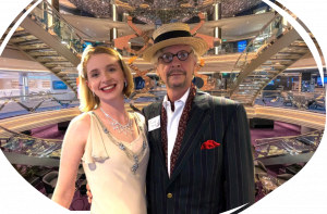 A man and a woman in 1920s costume stand in front of one of many of the bars on board the MSC Virtuosa