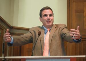 Bucks County expert Ryan Abramson standing at a podium presenting on authentic communication to an audience of students and parents at Holy Ghost Prep.