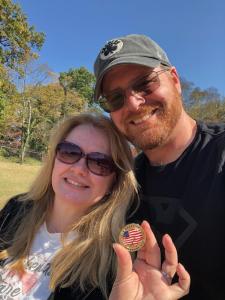 Allison Lyon and boyfriend Kevin Renault show off a coin found stuck under a playscape step, winning $1,000 in the Great US Treasure Hunt