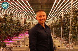 David Bernard, COO of C4USA, stands confidently in front of a vibrant cannabis canopy, highlighting the company's innovative approach to sustainable cannabis cultivation.