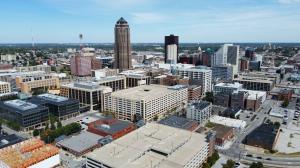 Aerial photo of Downtown Des Moines, Iowa, featuring office buildings, parking structures, and the iconic city skyline on a clear day.