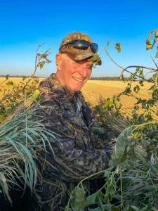 Randy Nieders in a duck blind on a sunny day