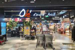 Directional speakers mounted in a supermarket, aiming to deliver targeted audio messages to customers in specific aisles.