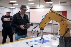 A Digital Foundry training participant working with a FANUC robot.