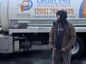 Drain Pro Plumbing & Septic owner Harman Kaler in front of his work truck.