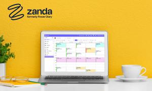 Zanda practice management software displayed on a laptop screen, featuring a detailed calendar interface for scheduling. The scene includes a yellow background, a coffee cup, glasses, and a plant, emphasizing a modern, productive workspace.