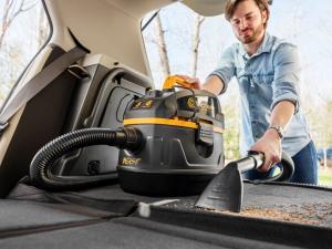 A man vacuums crumbs from a car trunk with the Vacmaster Professional Beast Series 5-Gallon wet/dry vacuum