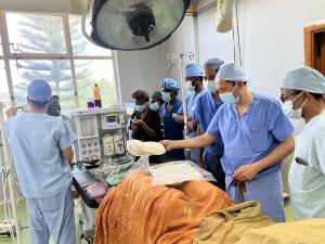 Dr. Khosla demonstrating advanced surgical techniques to a group of Ethiopian surgeons, highlighting efforts to improve healthcare access and training in underserved regions.