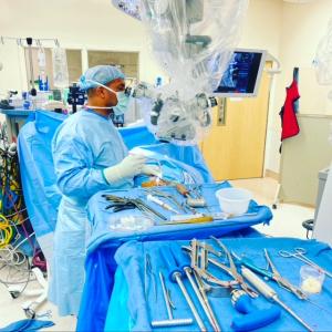 Dr. Ersno Eromo conducting a neurosurgical and orthopedic spine procedure with precision and cutting-edge equipment.