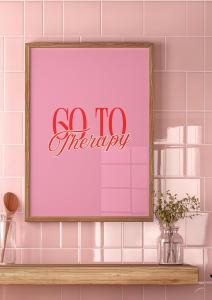 Framed "Go To Therapy" poster with bold typography, displayed on a pink tiled wall with a wooden shelf and decorative jars.