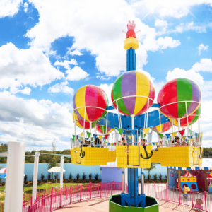 Colorful balloon ride at an amusement park on a sunny day.