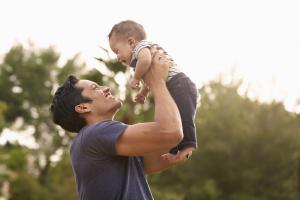 Father holding up baby
