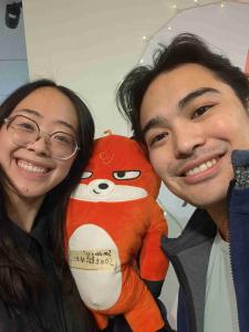 2 Scavenger Hunt team members take a selfie with a stuffed fox to complete an objective
