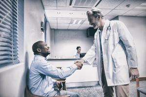 Doctor shaking hands with a black man