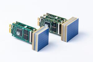 Two heat modules for the thermoforming  are shown. The surface has an array of visible heat pixels. They can be individually programmed for a specific temperature. Behind these two heat modules, the electronics are presented visibly on the photograph.