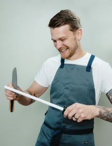 image of Celebrity Chef Austin Beckett sharpening his knives