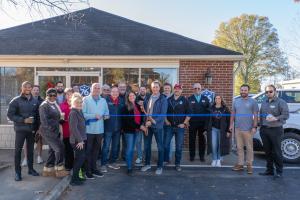 Group of people participating in a ribbon cutting ceremony for 76 FENCE in North Carolina