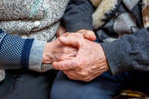 Retired couple holding hands