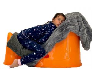 Young child using Tum&Bum incline sleep chair to fall asleep while she is congested and sick.
