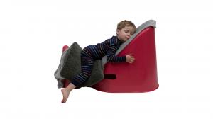 A 3-year-old boy sleeping comfortably and safely with his pillow and blanket on his watermelon-colored Tum&Bum sleep chair.