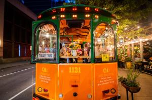 Guests dining in the AYZA Trolley, a vintage space in Midtown Manhattan, celebrated for offering a unique culinary experience that blends charm, nostalgia, and modern appeal.