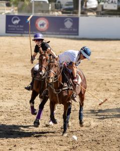 two female arena polo players on horses