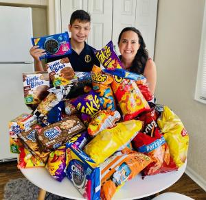  Gabriel Auais, in the 7th grade, and Children’s Harbor CEO & President, Tiffani Dhooge with Takis® box