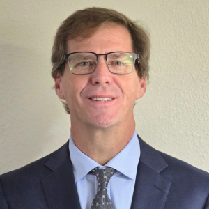 a photo of Daniel Francis in a blue suit, Daniel is the CEO of Orbiit Services Inc, the company offering the Orbiit Recovery Program