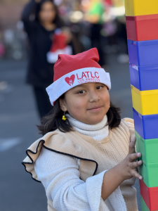 A child celebrating with her family at the ninth annual Los Angeles Trial Lawyers' Charities 