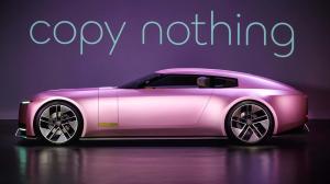 A sleek, futuristic Jaguar electric vehicle in a metallic pink finish, displayed in a minimalistic setting with the tagline 