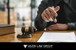 A lawyer from Vaziri Law Group using a pen to review legal documents, symbolizing meticulous preparation and advocacy for accident victims.