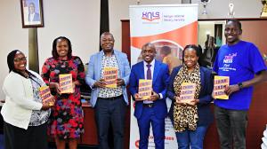 Kenya National Library Service and The Trueness Project representatives hold copies of Think and Grow Rich, a section of the 500 books donated by The Trueness Project as flagship donation after signing an MoU with KNLS. Photo by Godfrey Atsing'a, The Trueness Project.