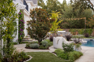 backyard with pool, greenery, comfy chair and walkways