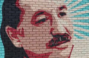 Leonard Peltier portrait on brick wall